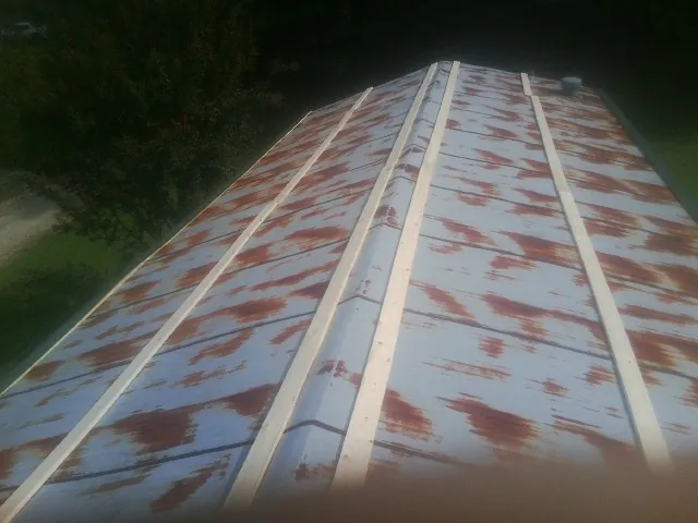 Rusted metal roof panels with new wood purlins before replacement — Storm Damage Roof Repair in Pamplin by Roofing Brothers