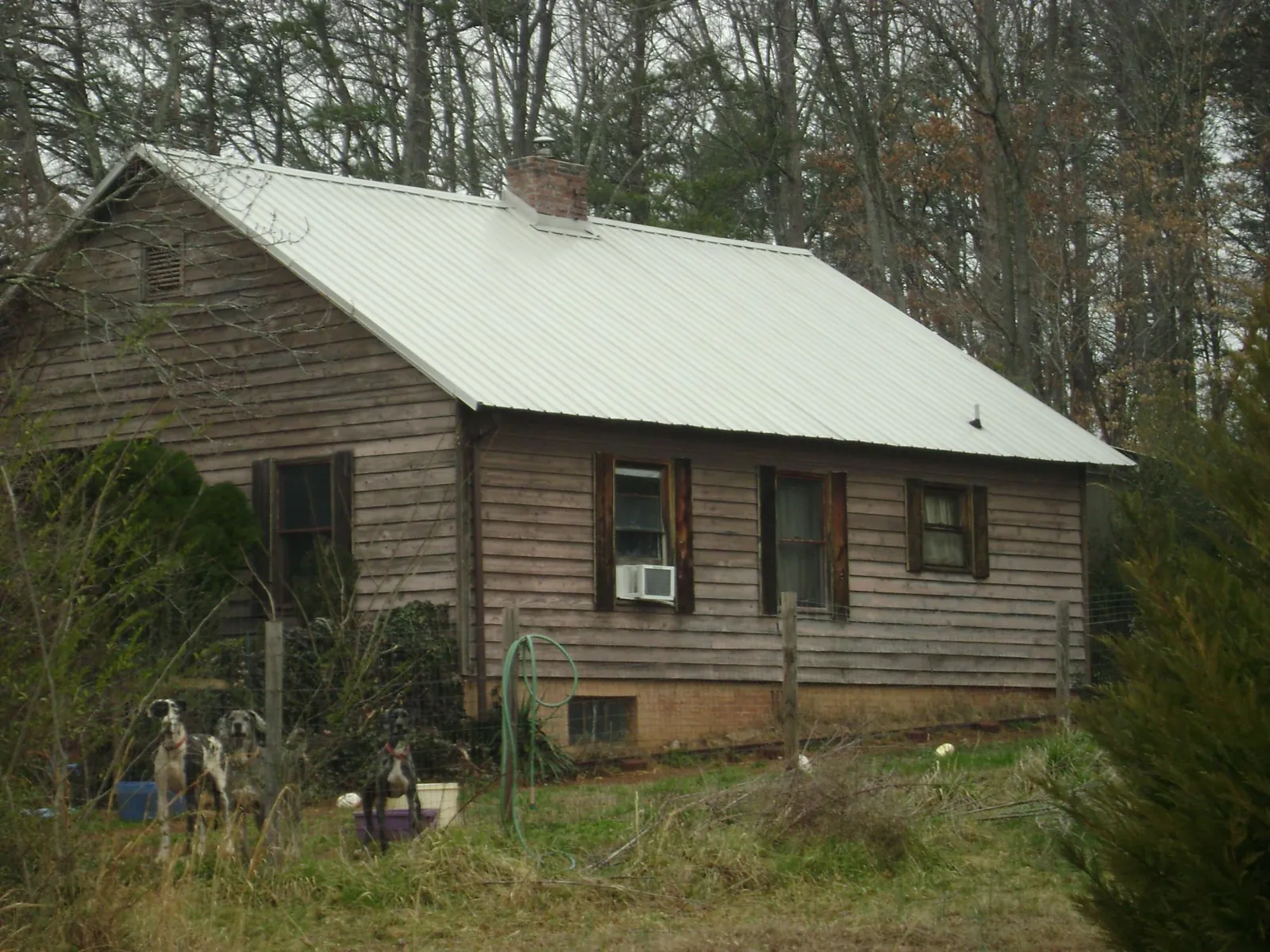 White metal roof on an old wood sided farmhouse, from a Metal Roof Installation job in Pamplin